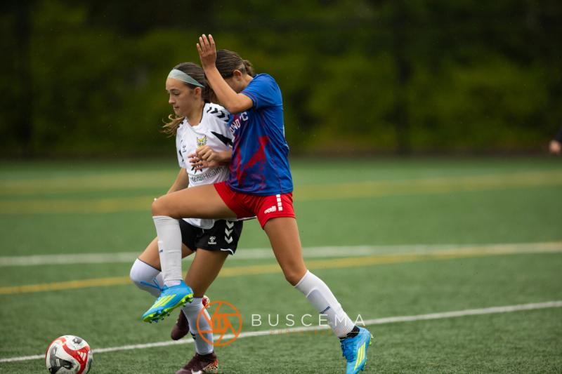 Sting 13-14G Academy and Sound FC players challenging for a high ball