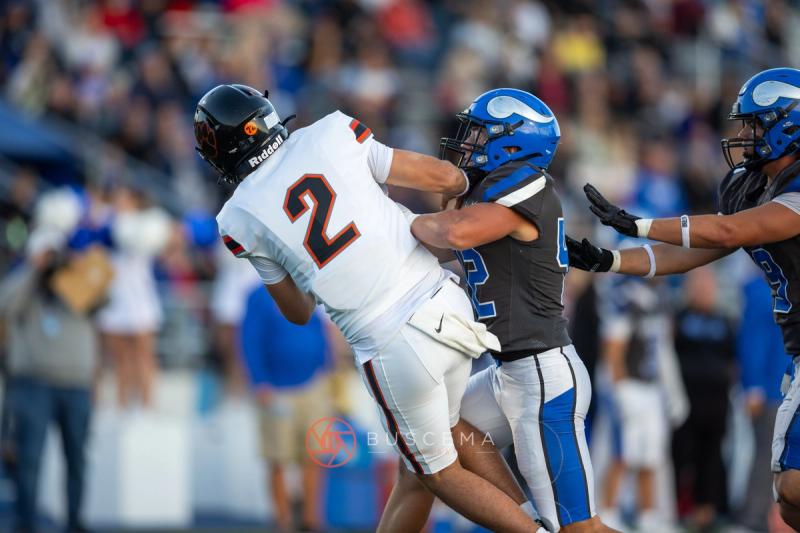 A Coeur d'Alene defender meets Lewis and Clark number 2 near the sideline