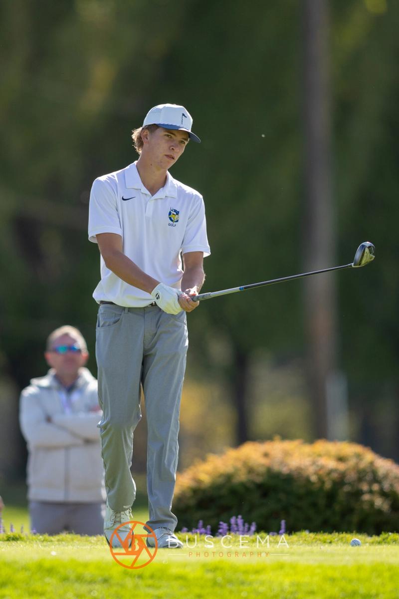 Boys golfer watching his tee shot at the 6A state golf championships at Avondale Golf Club