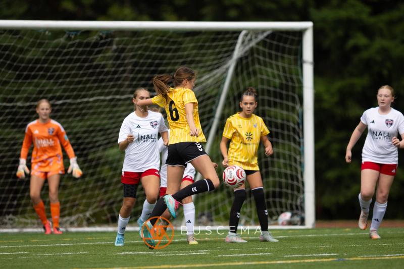 Play in front of the Mt. Rainier goal with the keeper off her line