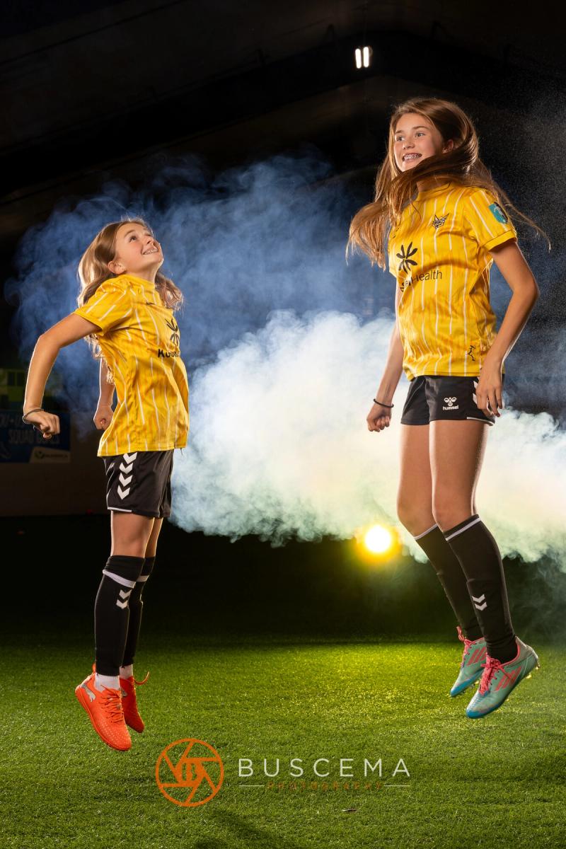 Two Sting 13G Academy players jumping in the air