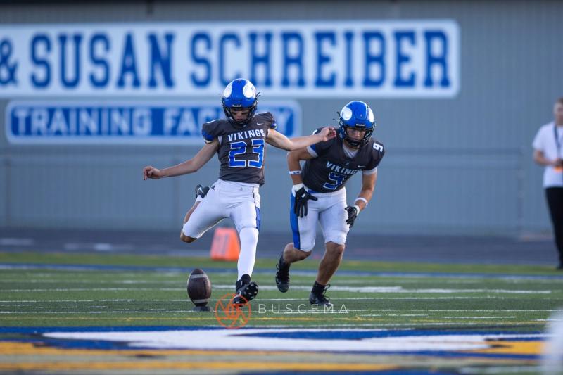 Coeur d'Alene kicker number 23 striking the opening kickoff at Viking Field