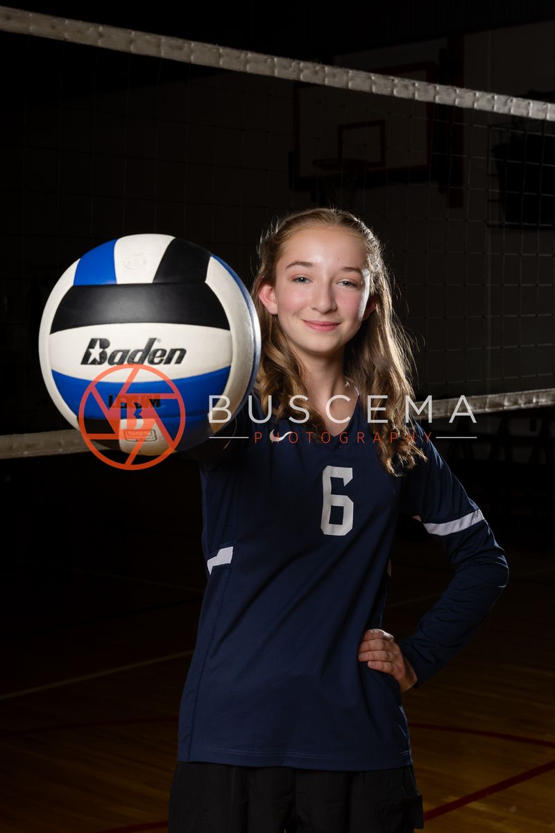 Coeur du Christ Academy volleyball player in a number 6 jersey balancing a volleyball