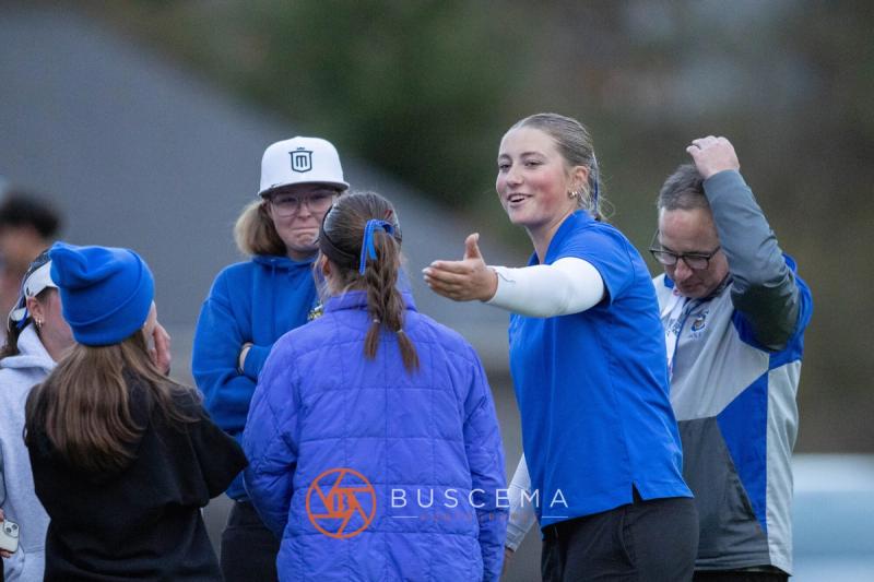 Coeur d'Alene golfers and coaches celebrating near the green at the 6A state golf championships at Avondale Golf Club