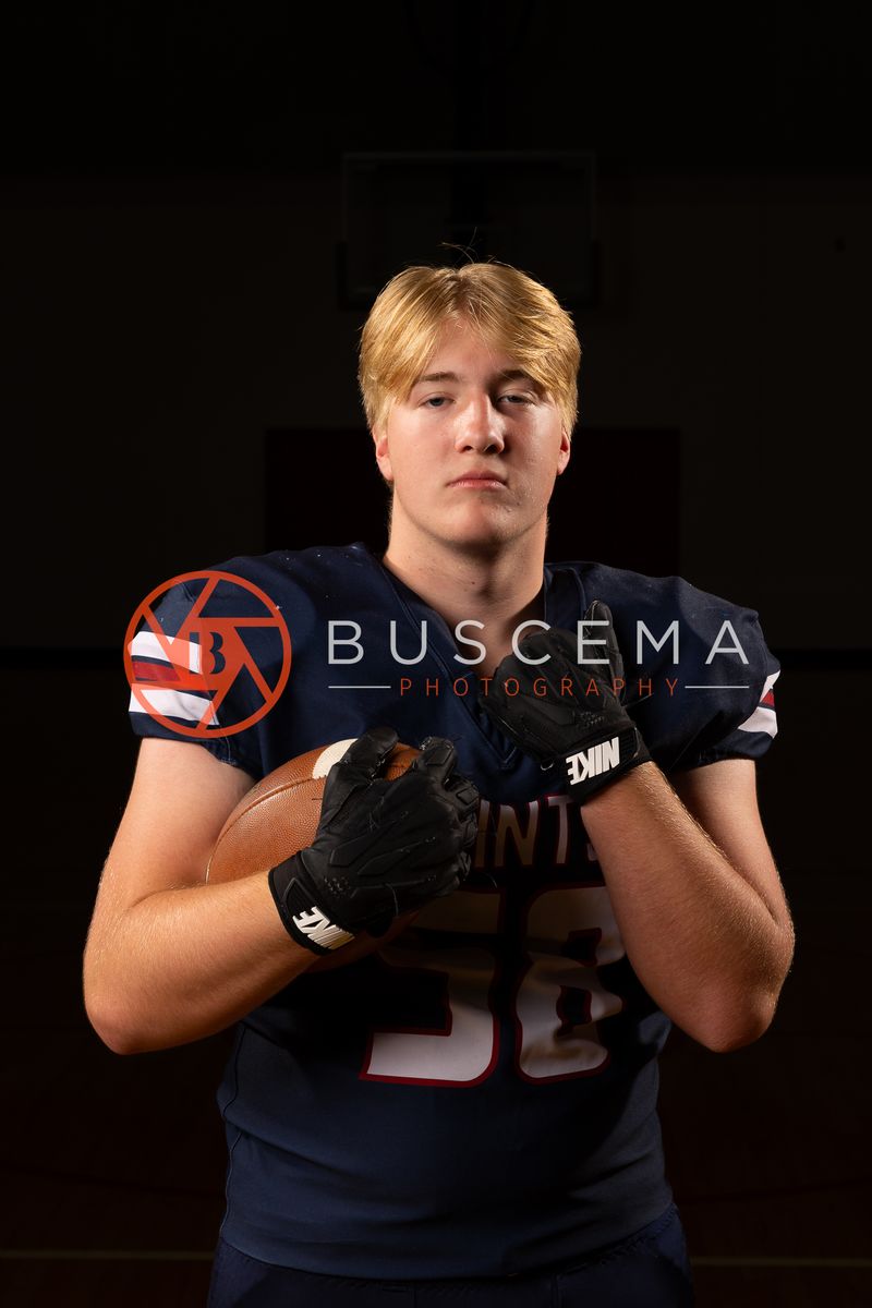 Coeur du Christ Academy football player in a Saints uniform and gloves