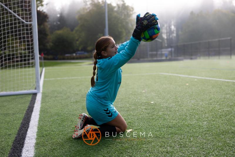 Sting 13G Academy goalkeeper on her knees after catching the ball