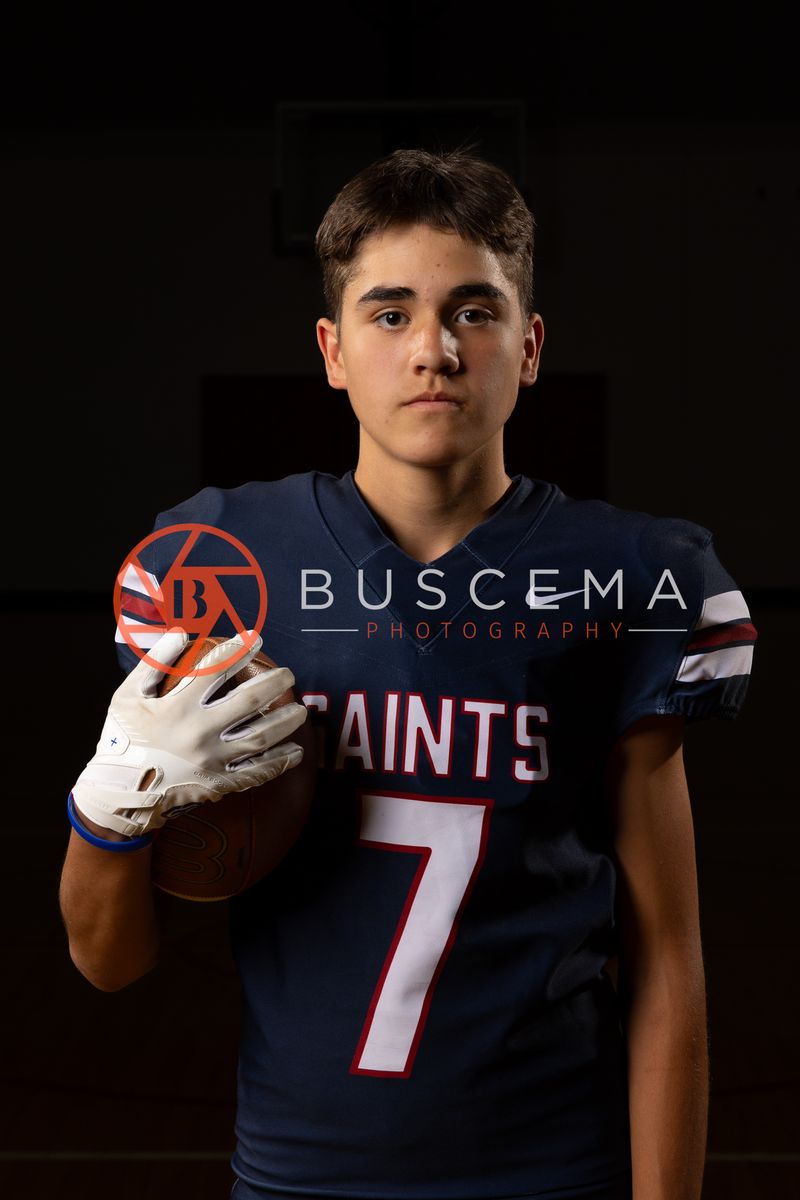 Coeur du Christ Academy Saints football player in a number 7 jersey holding a football