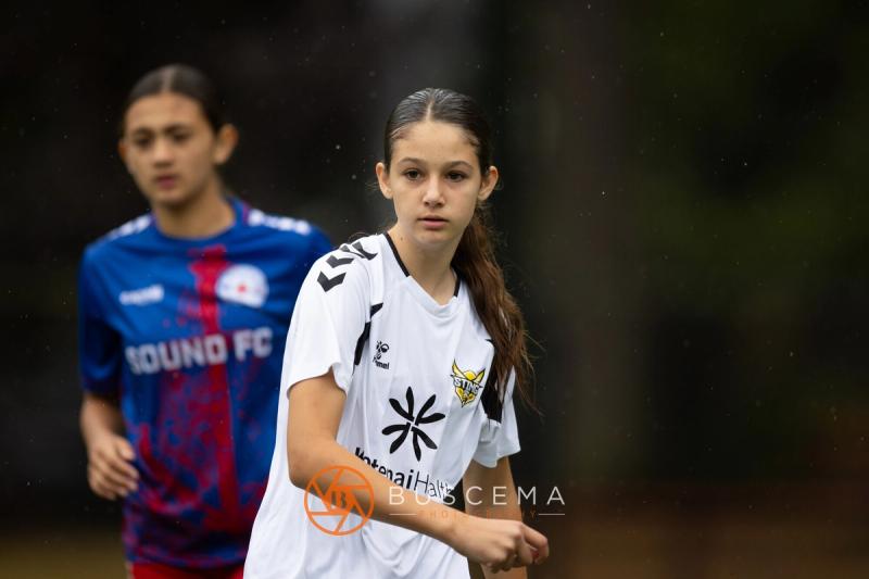 Sting 13-14G Academy player running with a Sound FC player behind her