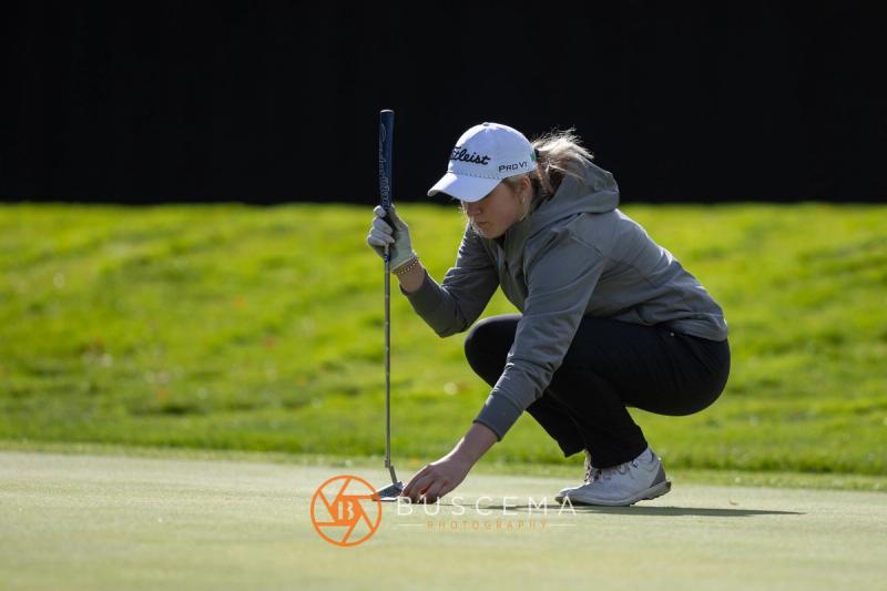 Girls golfer reading the green with her putter at the 6A state golf championships at Avondale Golf Club
