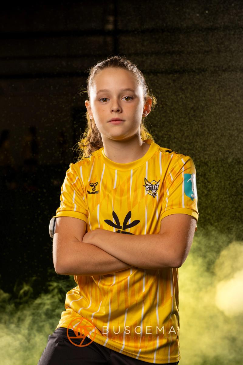 Sting 13G Academy player with her arms crossed and a little smile