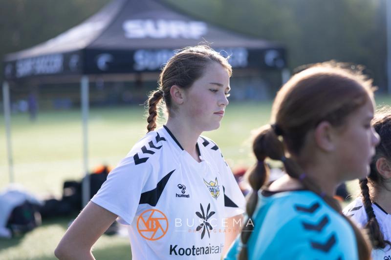 Sting 13G Academy player with a braid on the sideline at Bellevue