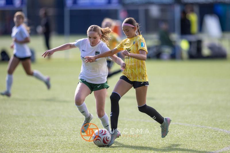 Sting 13G Academy player dribbling past a Harbor Premier defender