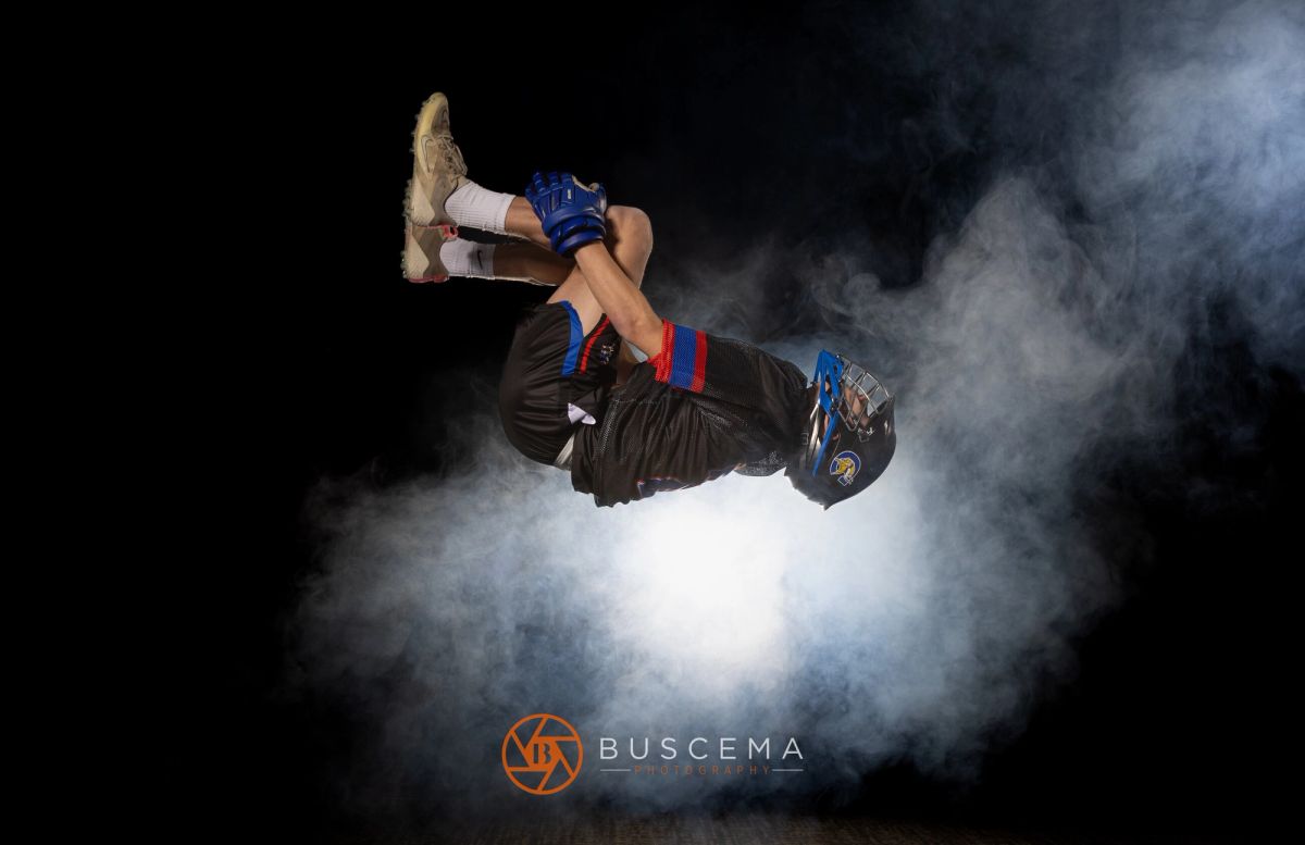 Athlete performing aerial flip in dramatic powder cloud during sports photography session