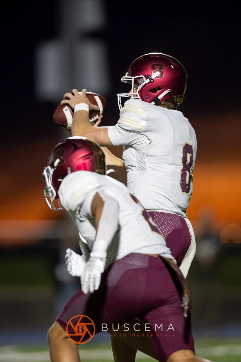Rigby's quarterback throwing under pressure against an orange sky