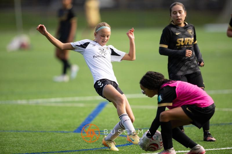 Sting 13G Academy player getting a shot off as the Western WA Surf keeper dives