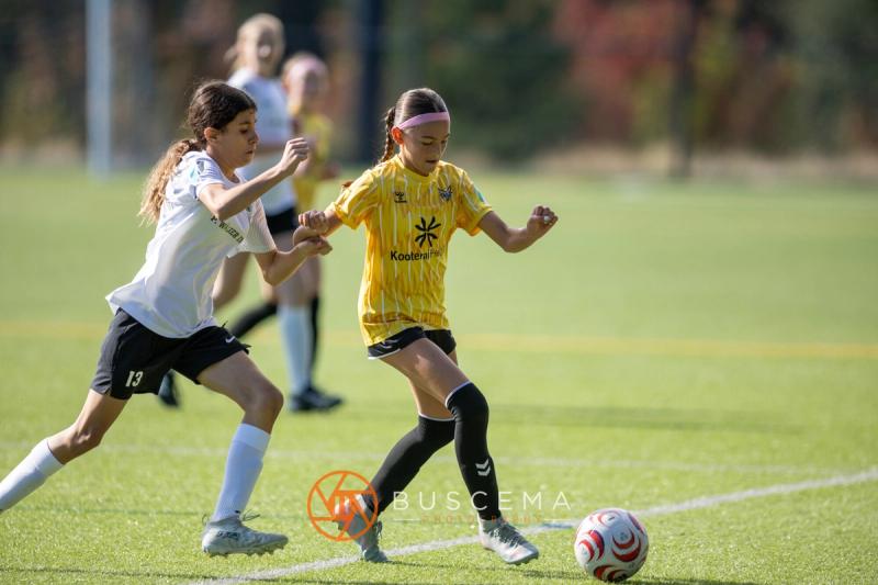 Sting 13G Academy player battling a Harbor Premier player for the ball