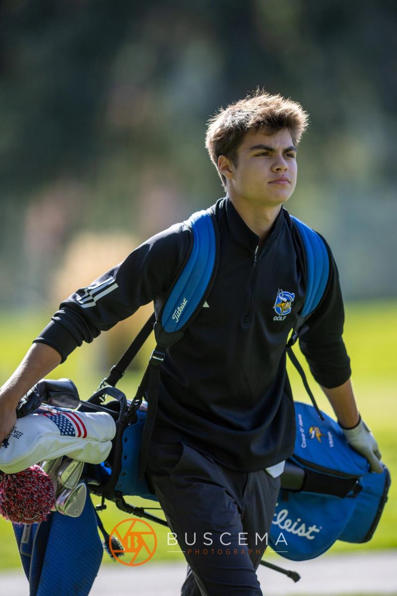 Golfer carrying his bag off the tee at the 6A state golf championships at Avondale Golf Club