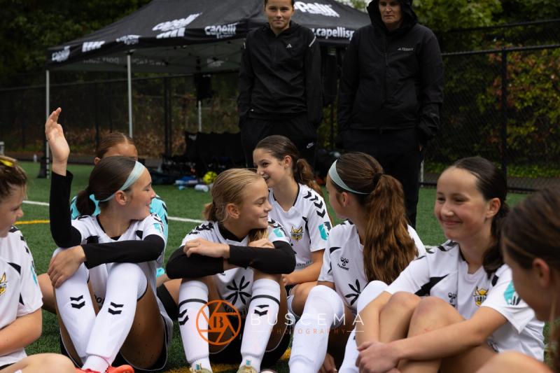 Sting 13-14G Academy players sitting together on the sideline