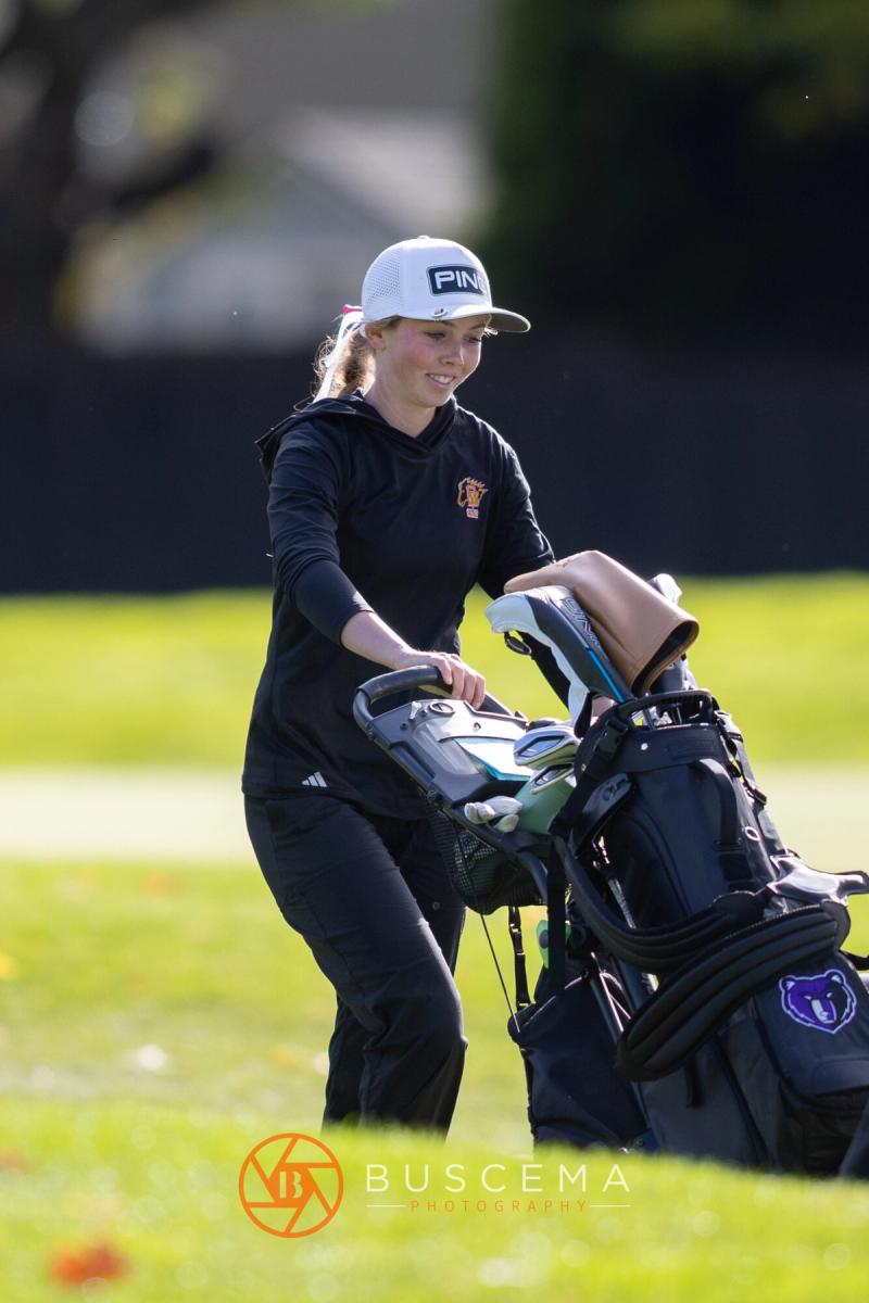 Girls golfer pulling a club from her bag at the 6A state golf championships at Avondale Golf Club