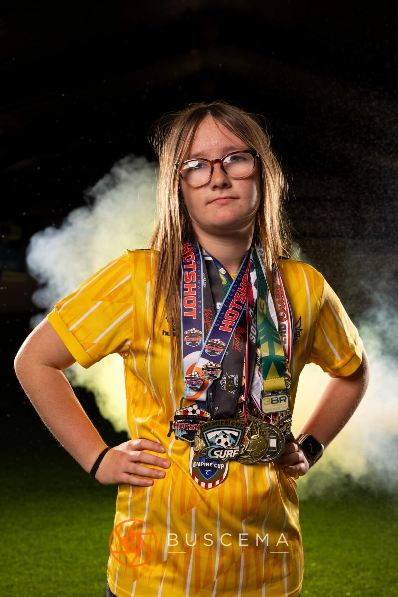 Sting 13G Academy player wearing all of her tournament medals