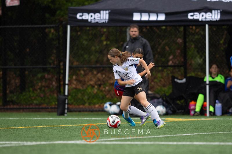 Sting 13-14G Academy player on the ball near the touchline