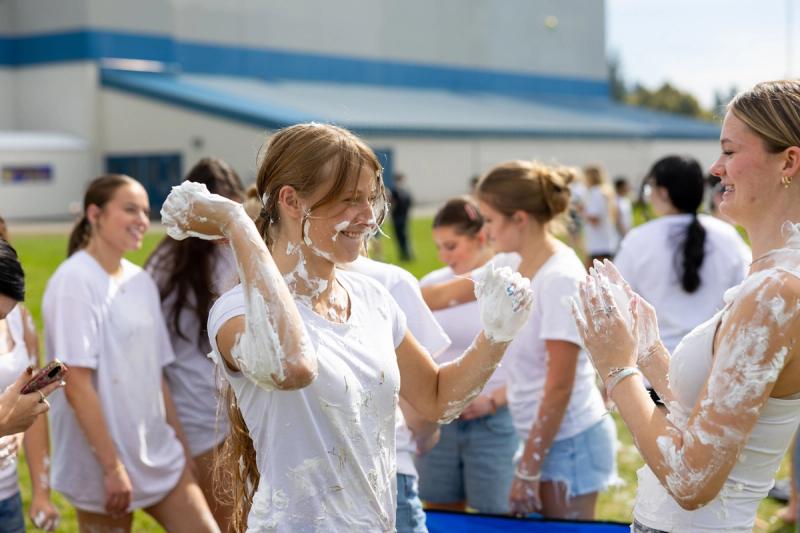 Coeur d'Alene senior with shaving cream down her arm during the cream fight