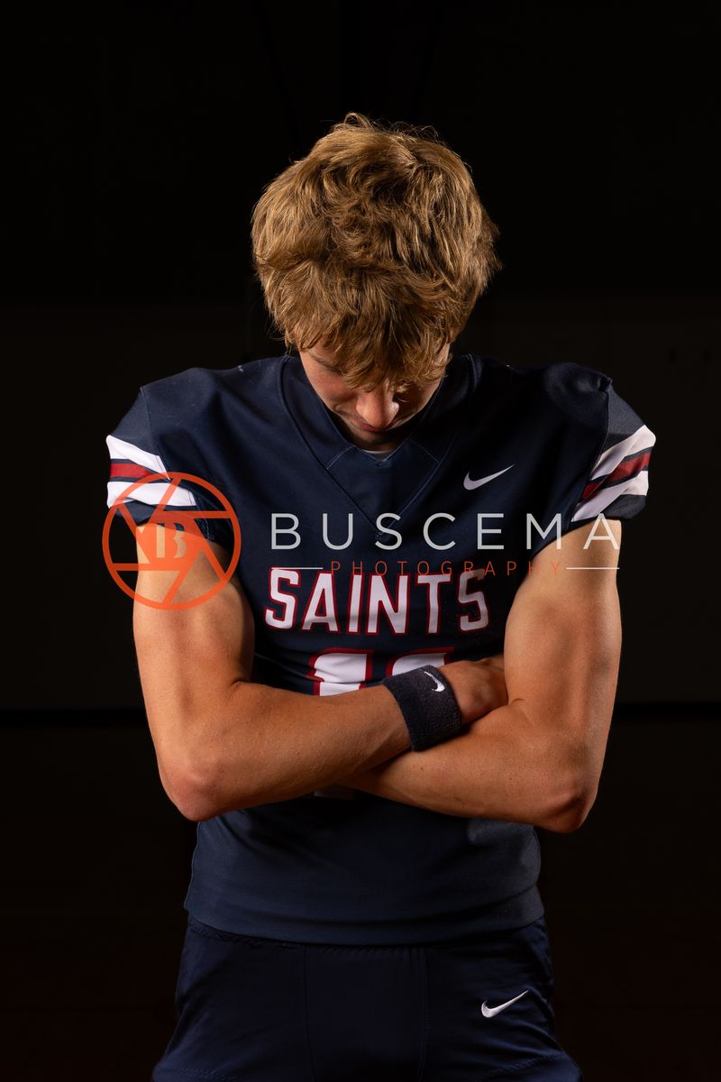Coeur du Christ Academy Saints football player with arms crossed in the gym