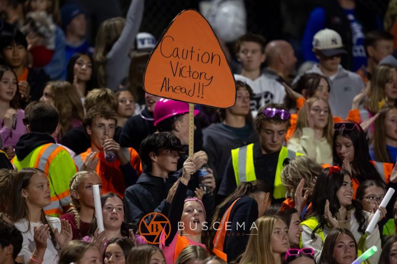 A Coeur d'Alene fan holds a Caution Victory Ahead sign in the student section