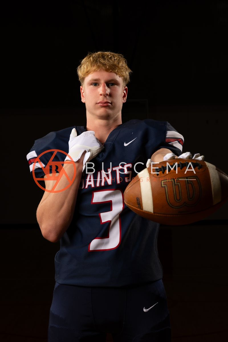 Coeur du Christ Academy football player in a number 3 jersey holding a football