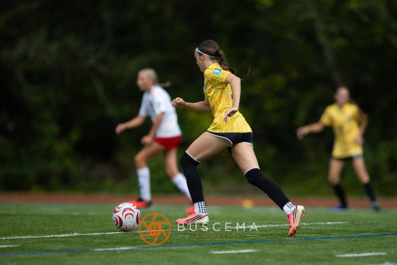 Sting 13-14G Academy player carrying the ball upfield against Mt. Rainier