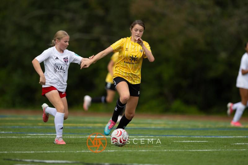 Sting 13-14G Academy player breaking forward with a Mt. Rainier defender chasing