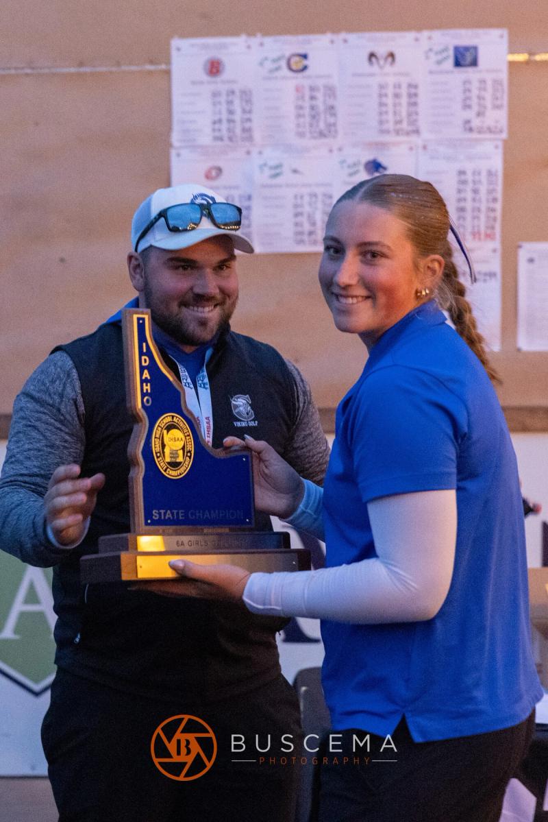 Coeur d'Alene girls golfer receiving the state championship trophy at the 6A state golf championships at Avondale Golf Club