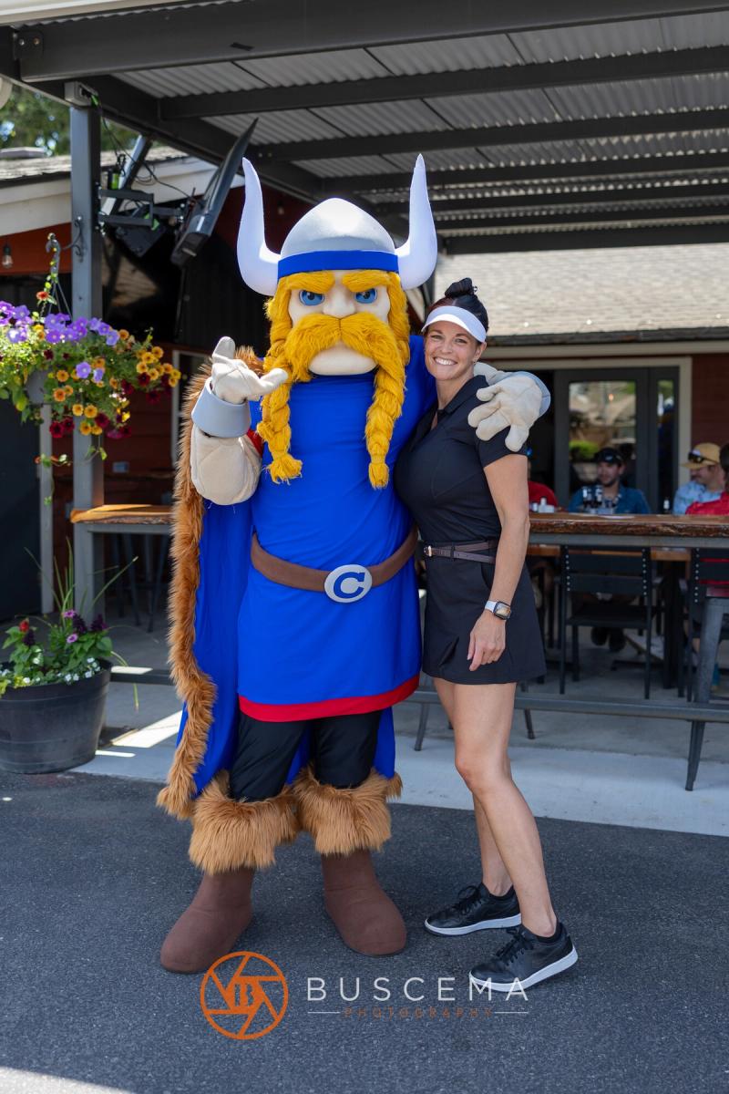 The Viking mascot posing with a golfer outside the Avondale clubhouse