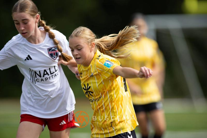 Sting 13-14G Academy and Mt. Rainier players racing for the ball