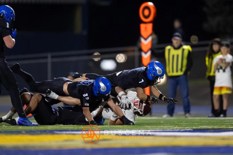 Coeur d'Alene defenders bring down a Rigby ball carrier near the sideline