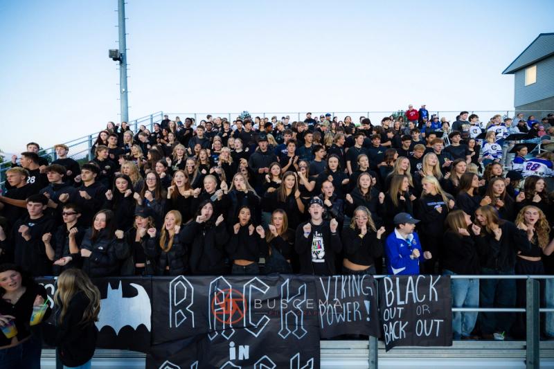 The Coeur d'Alene student section in a blackout theme with hand painted signs