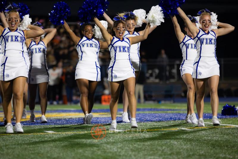 Coeur d'Alene cheerleaders performing on the field under the lights at Viking Field