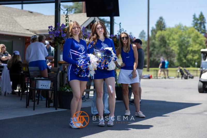 CHS cheerleaders with pom poms greeting golfers outside the Avondale clubhouse