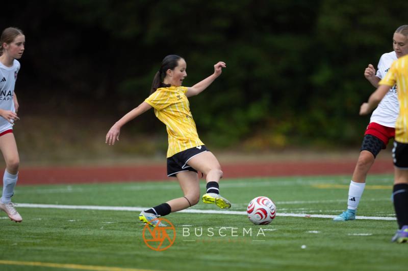 Sting 13-14G Academy player striking the ball against Mt. Rainier