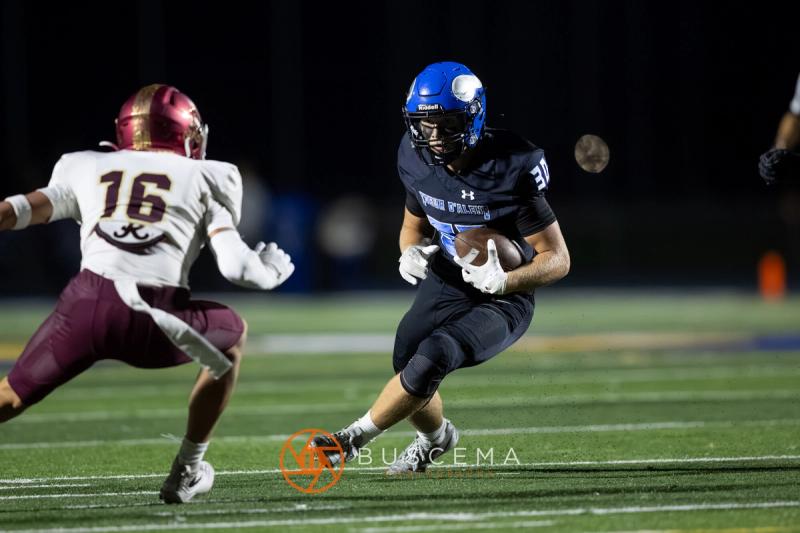 A Coeur d'Alene ball carrier pulls away from a Rigby defender