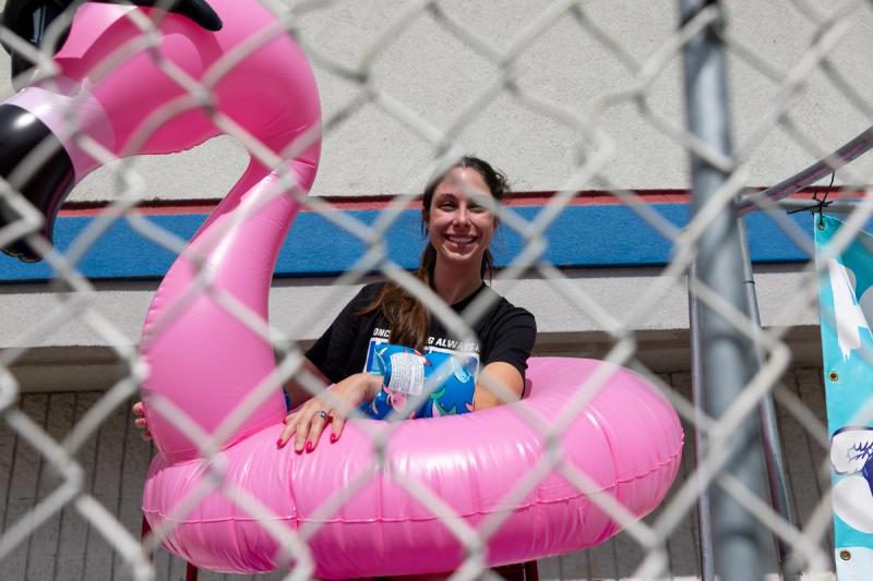 A woman in the dunk tank cage with a pink flamingo float at the Coeur d'Alene senior kickoff