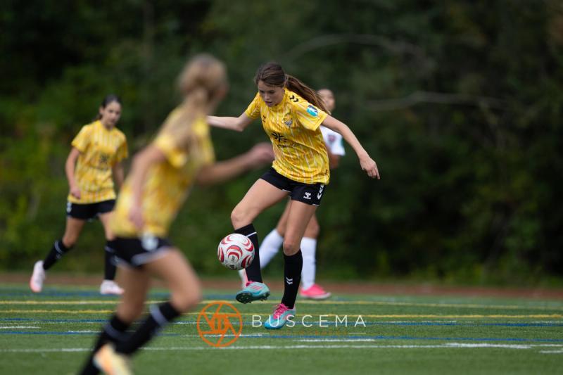 Two Sting 13-14G Academy players converging on the ball