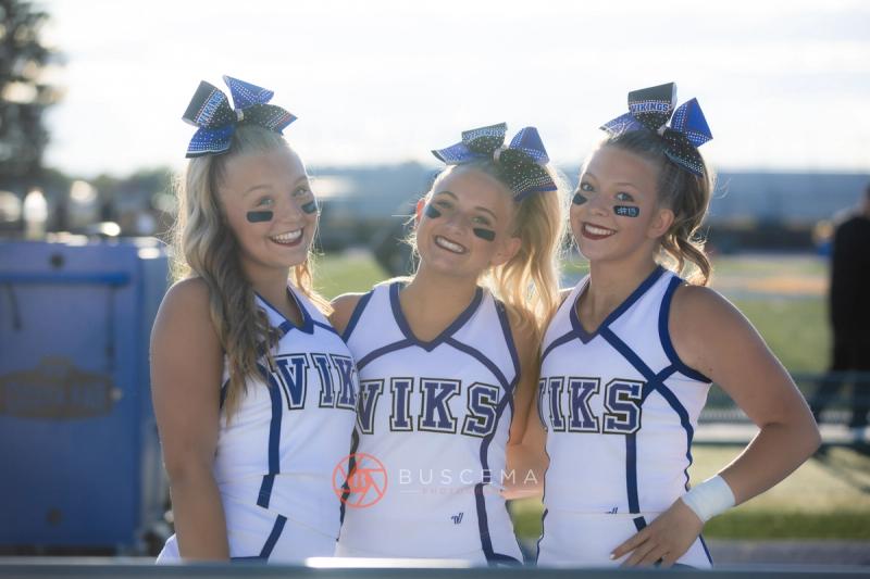 Three Coeur d'Alene High School cheerleaders posed together in Viks uniforms