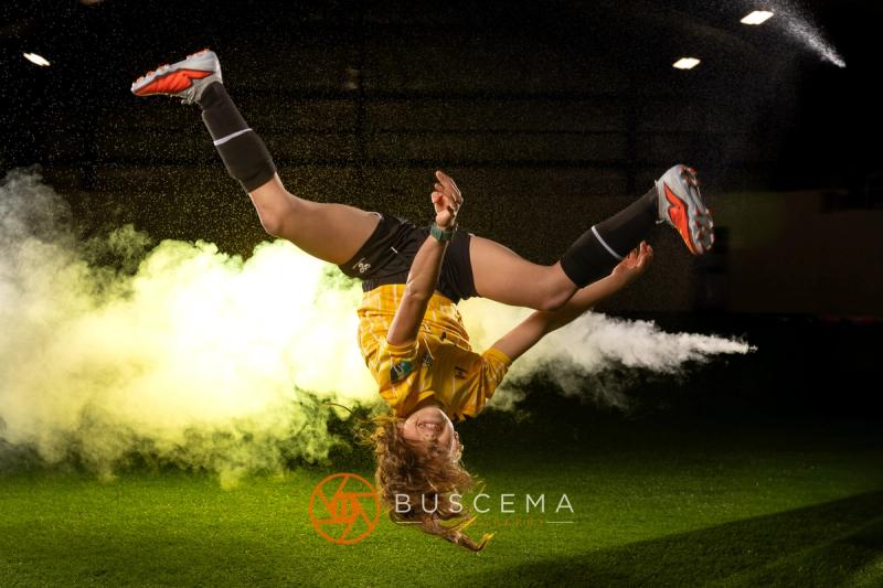 Sting 13G Academy player doing a flip in front of the smoke