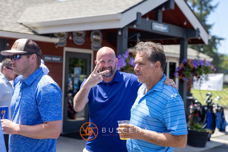 Golfers laughing together outside the pro shop before the round