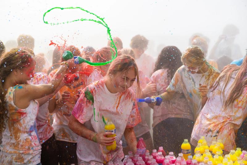 A stream of green color arcing over Coeur d'Alene seniors at the color throw