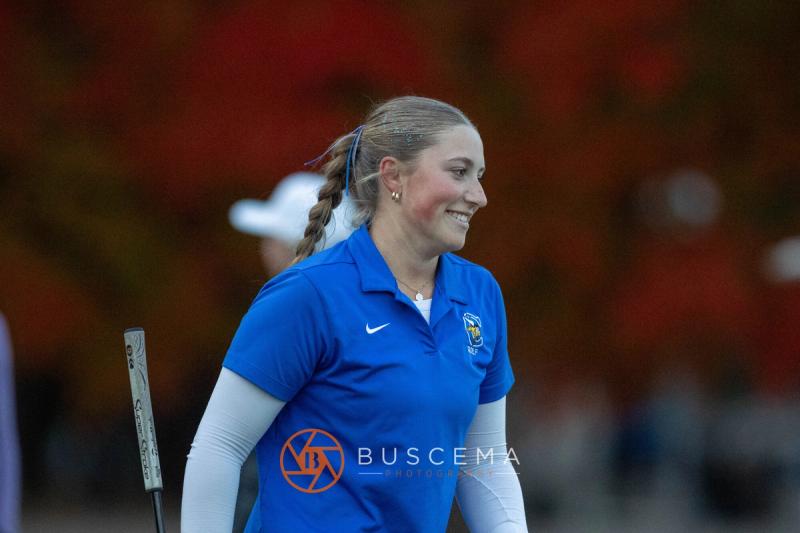 Coeur d'Alene girls golfer smiling with fall colors behind her at the 6A state golf championships at Avondale Golf Club