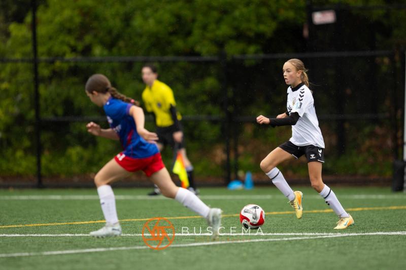 Sting 13-14G Academy player chasing down the ball against Sound FC