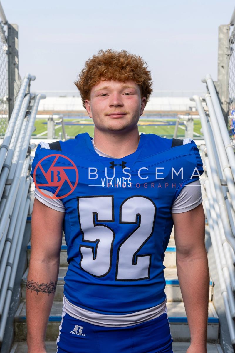 Coeur d'Alene Vikings football player in a number 52 jersey on the bleacher steps