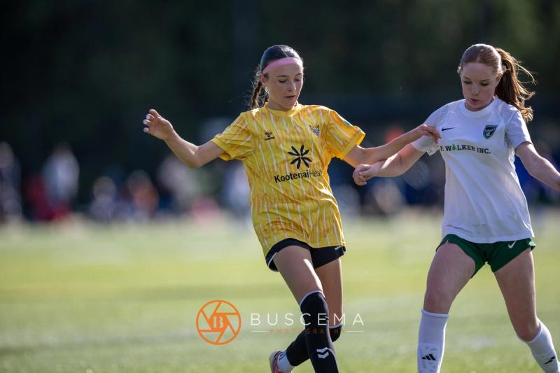 Sting 13G Academy player racing a Harbor Premier player to the ball